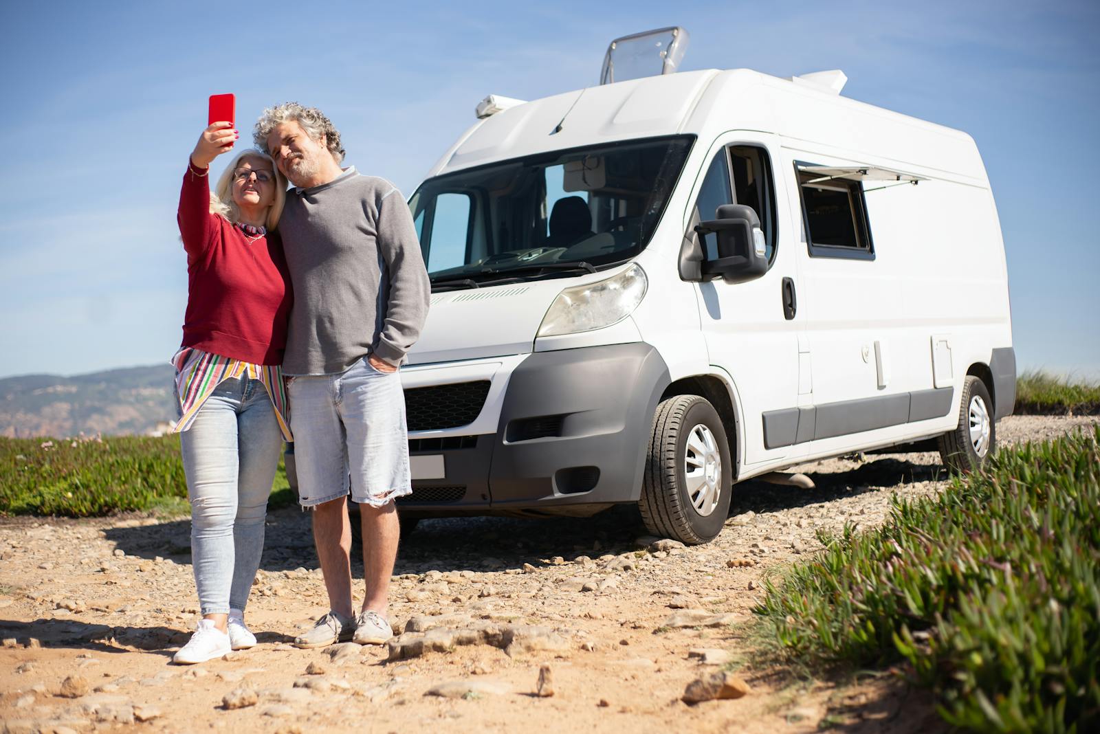 An Elderly Couple Taking a Selfie beside Their Recreational Vehicle